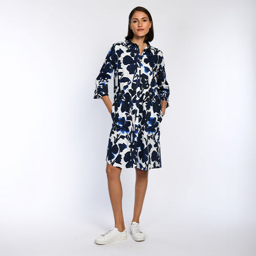Das Model trägt ein Hemdblusenkleid mit Perlenstickerei.