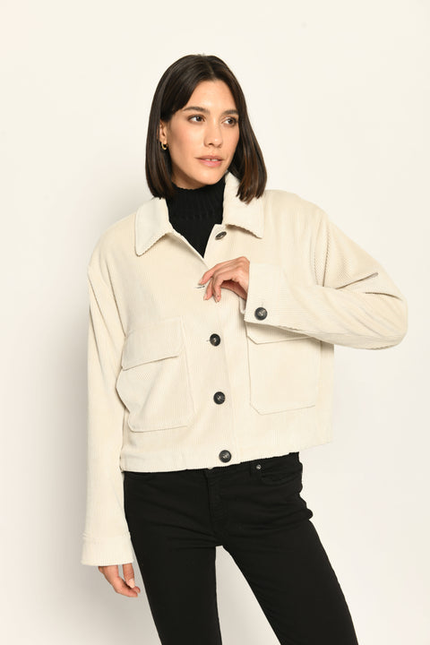 Cord-Blouson in der Farbe Creme mit großen Taschen und schwarzen Knöpfen, kombiniert zu schwarzer Hose – Vorderansicht