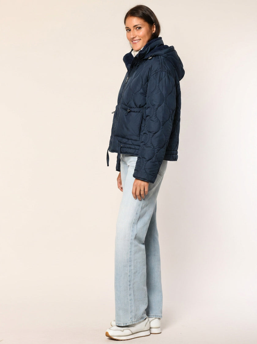 Gerade geschnittene Steppjacke mit Kapuze in der Farbe dunkelblau - Seitenansicht.