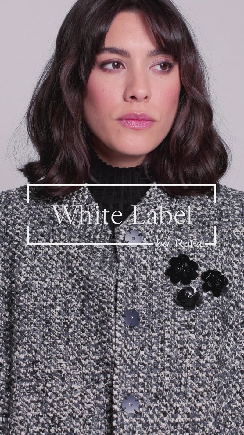 Model trägt Bouclé-Blouson für Damen in den Farben Schwarz und Weiß zu dunkler Stoffhose – Video