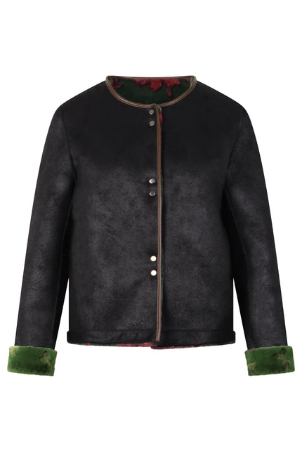 Wendejacke in Schwarz aus Velours mit innenliegendem Webpelz in der Farbe Grün mit flamingo-rosa-farbigem Blütendruck.